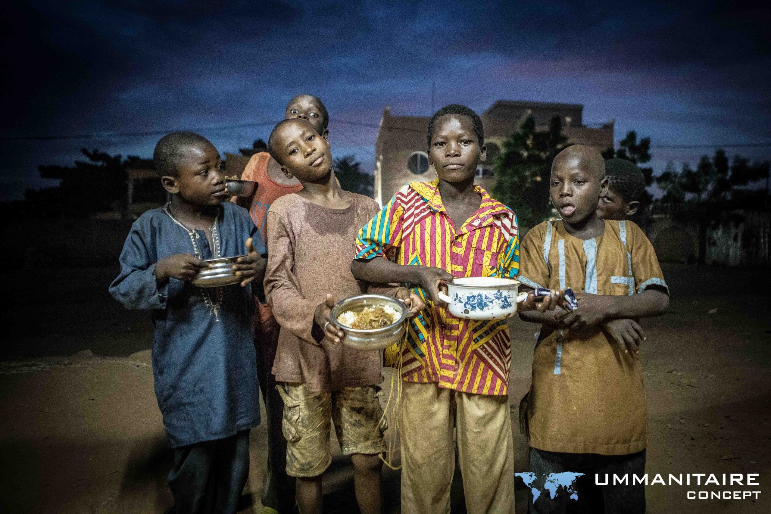 enfants des rues reçoivent des repas distribués par la cantine des rues de l'association ummanitaire concept